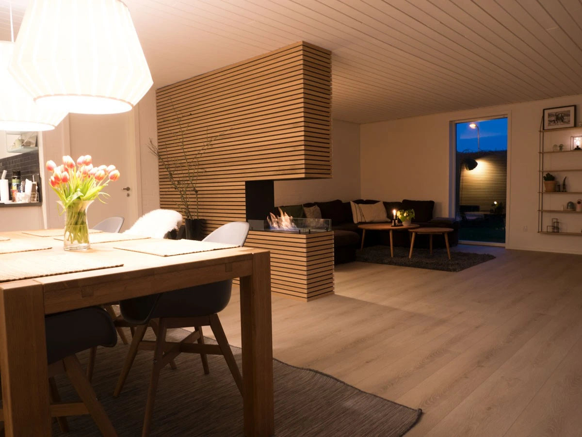 Foco Room Divider 800 installed in an open-plan dining and living room with lit ethanol flame