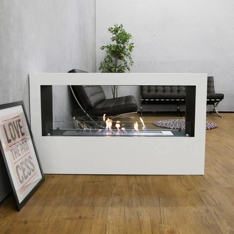 Lansing XL white bioethanol fireplace used as a room divider in a modern living space with concrete wall and black chairs