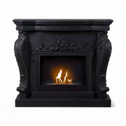 Ymir freestanding bioethanol fireplace with black polystone surround, lit flame, white background studio shot