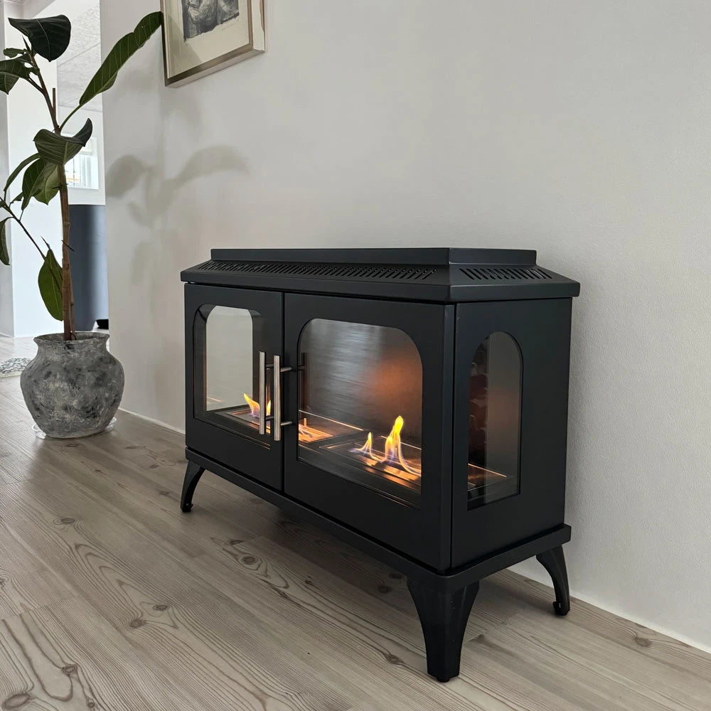ScandiFlames Atlanta Double bioethanol stove with lit flame in a modern living room beside a potted plant