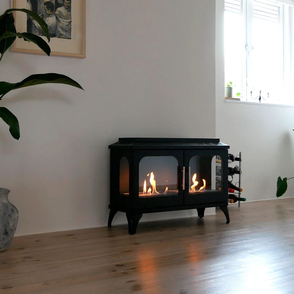 Atlanta Double bioethanol fireplace burning in a bright living room with wood flooring and a window