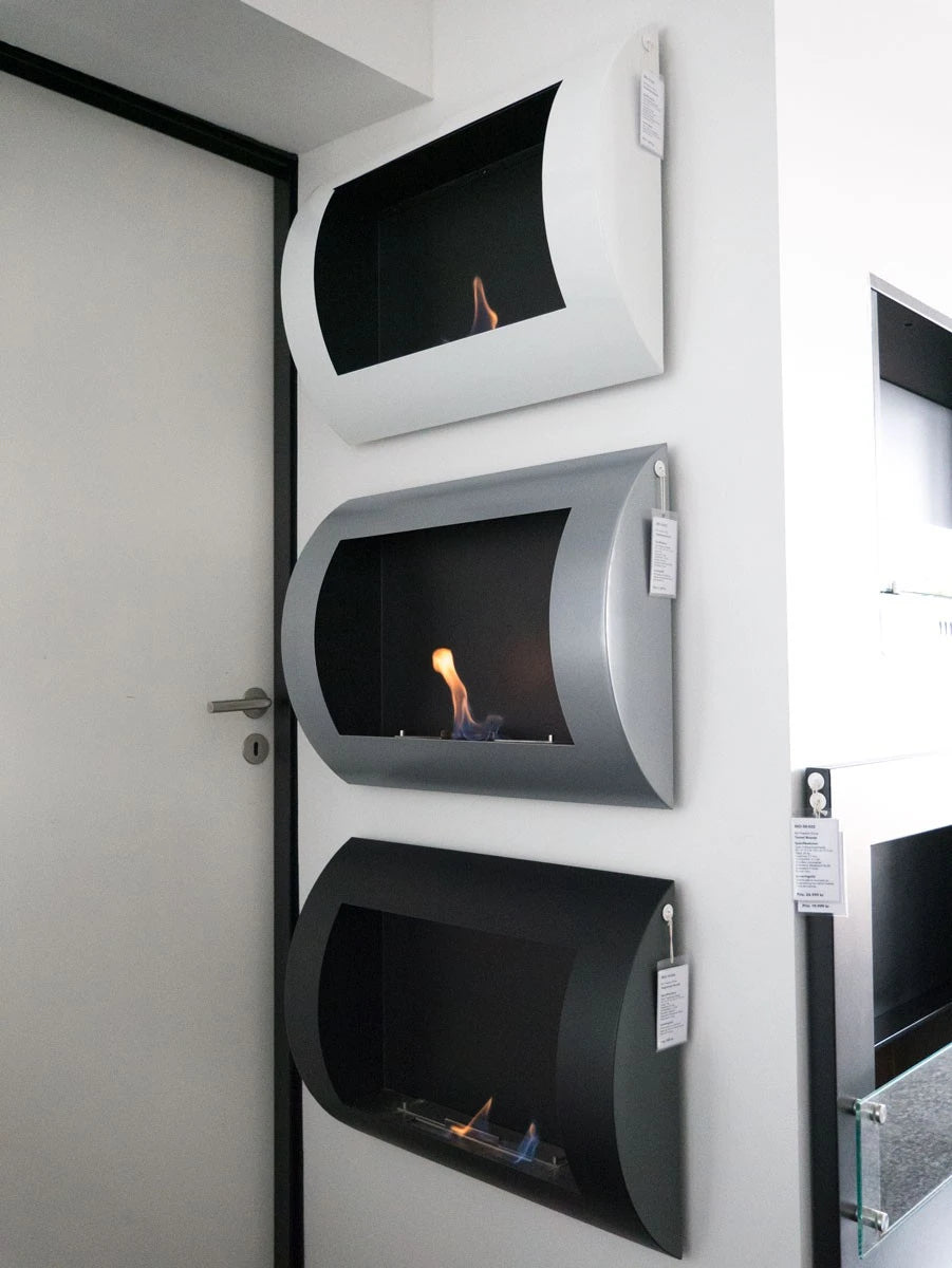 Ocean bioethanol fireplace finishes displayed on a showroom wall