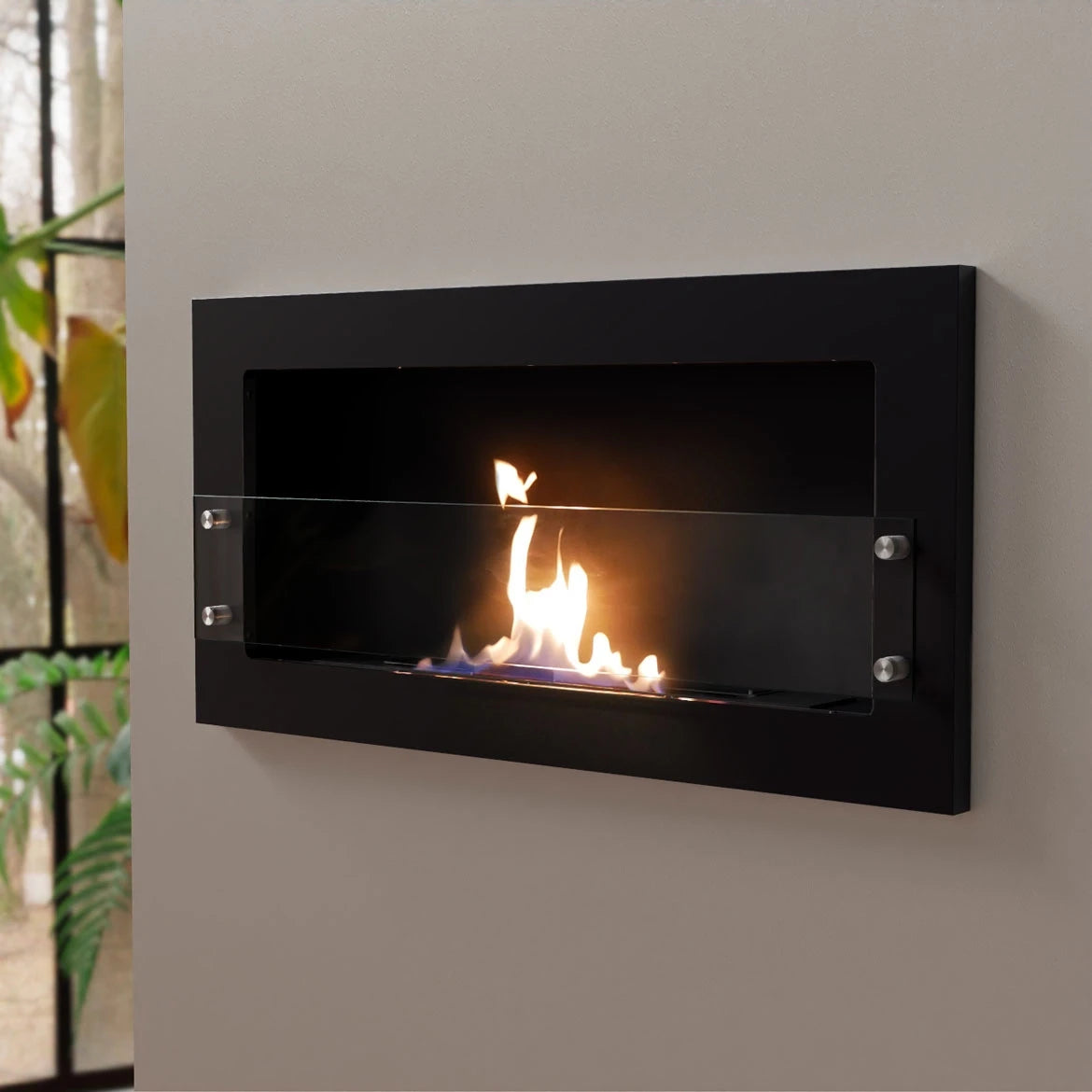 Texas black bioethanol fireplace mounted on a grey styled wall, opposite angled view with a lit flame