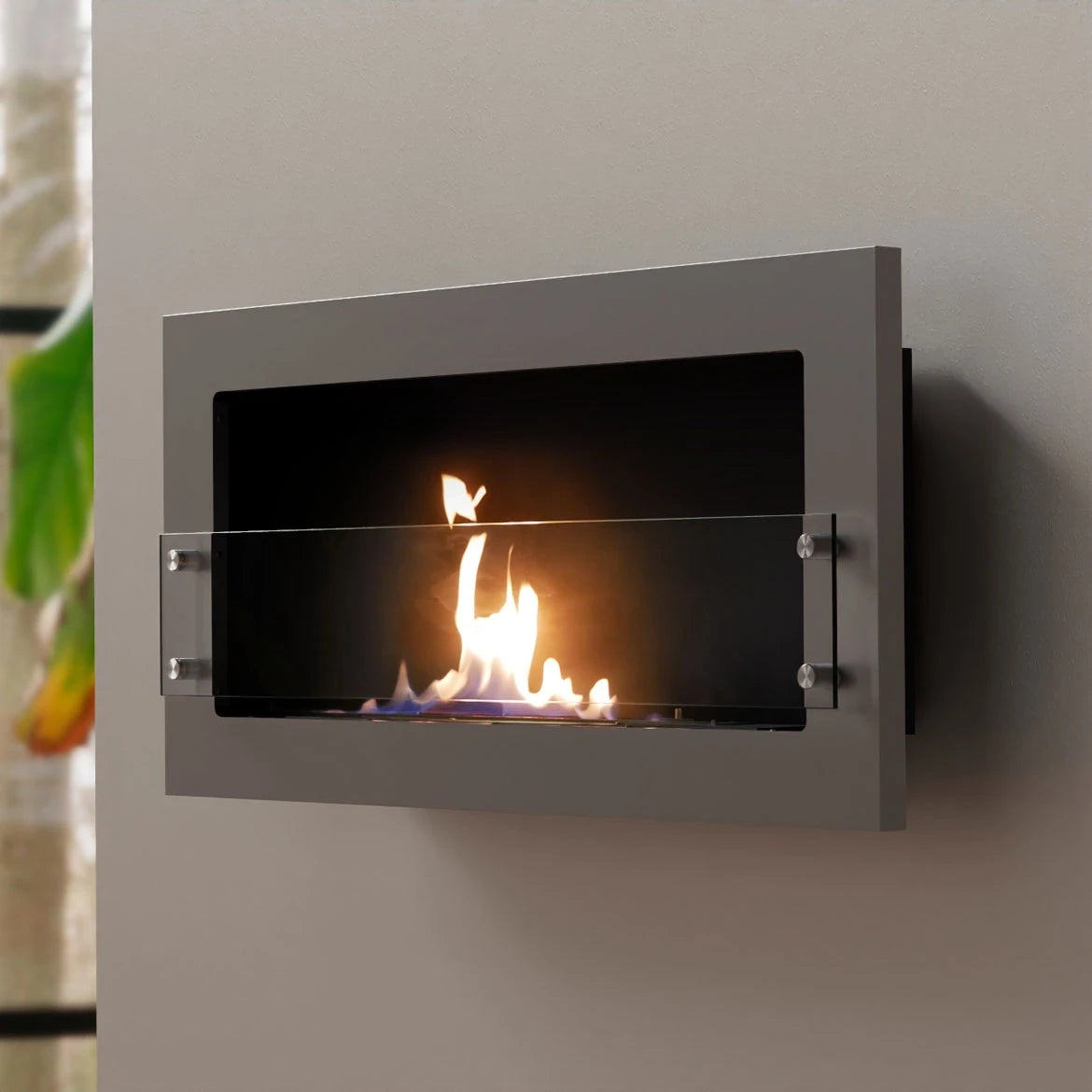 Texas steel-grey bioethanol fireplace mounted on a grey styled wall, angled view with a lit flame
