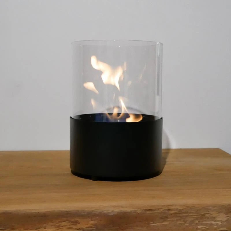 Close-up of the Kennington fireplace's lit flame flickering inside the glass cylinder