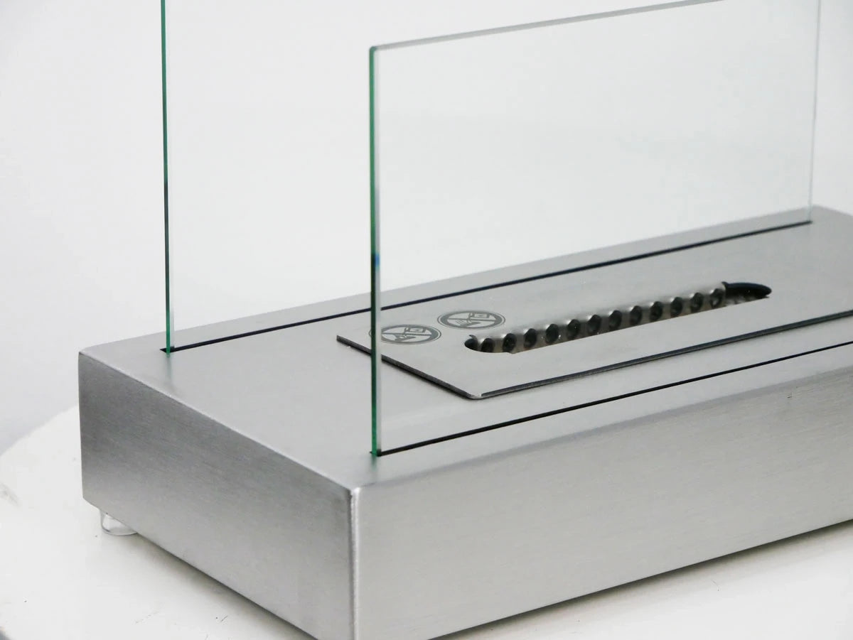 Close-up detail of the ScandiFlames Lambeth burner tray and extinguishing tool, unlit