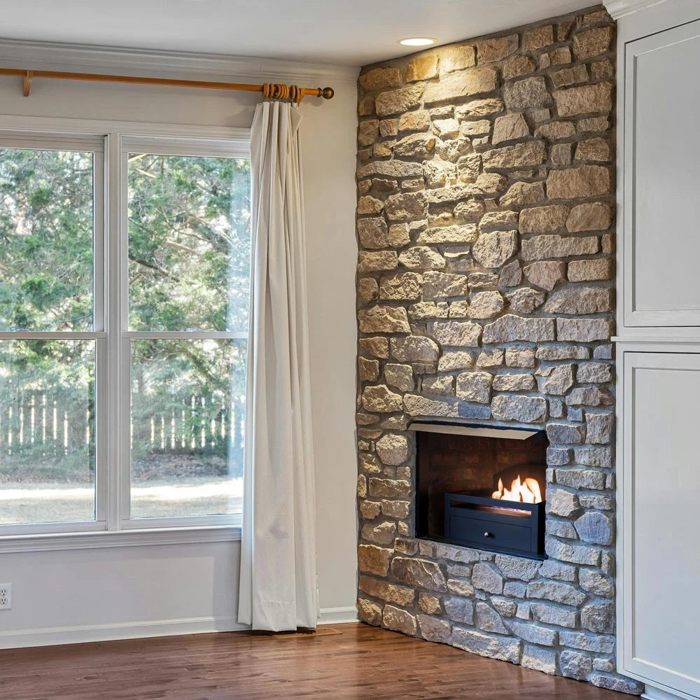 ScandiFlames Kingston bioethanol fireplace insert lit and retrofitted into a real stone fireplace opening