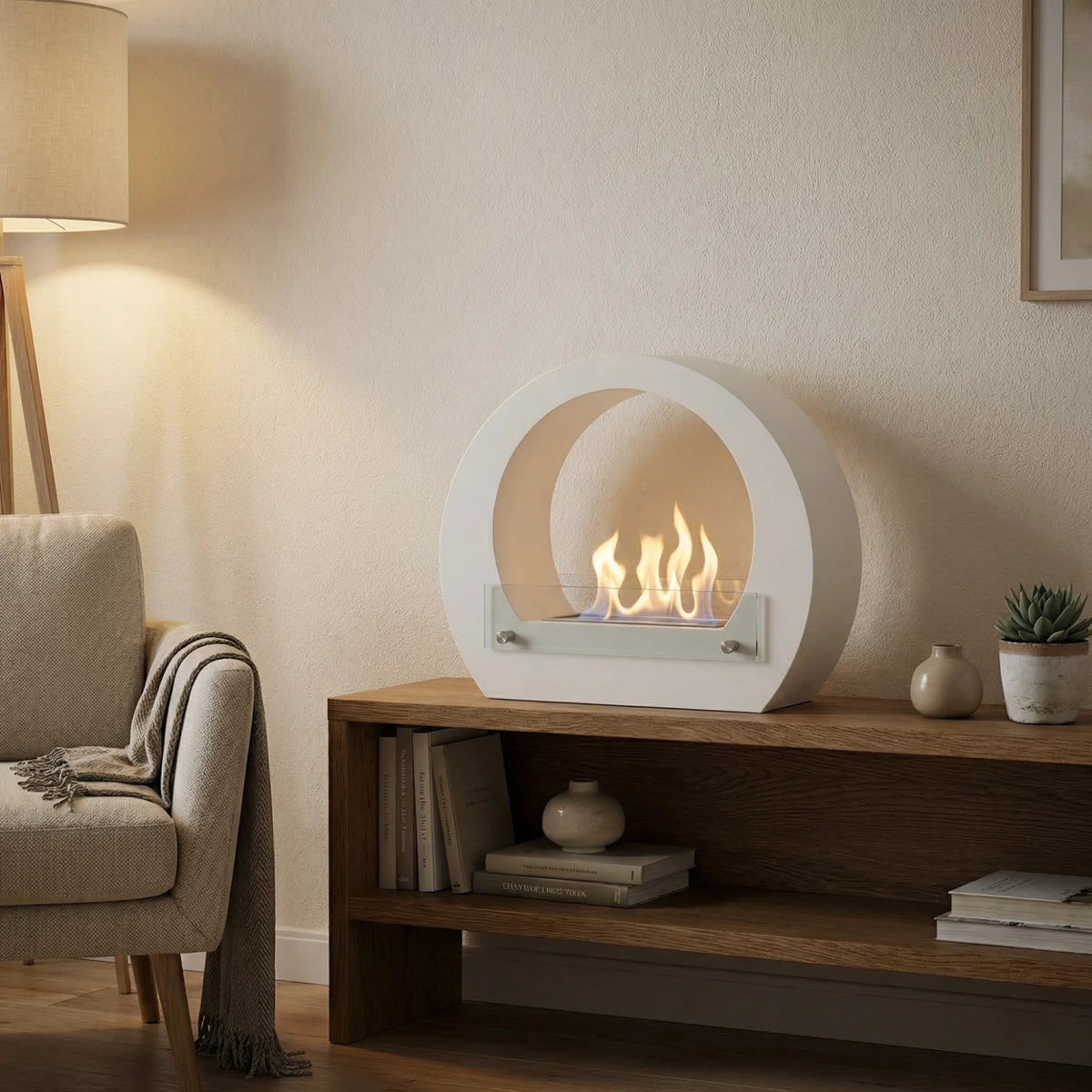 Dallas White freestanding bio fireplace on a wooden console with a beige armchair, lit realistic flame