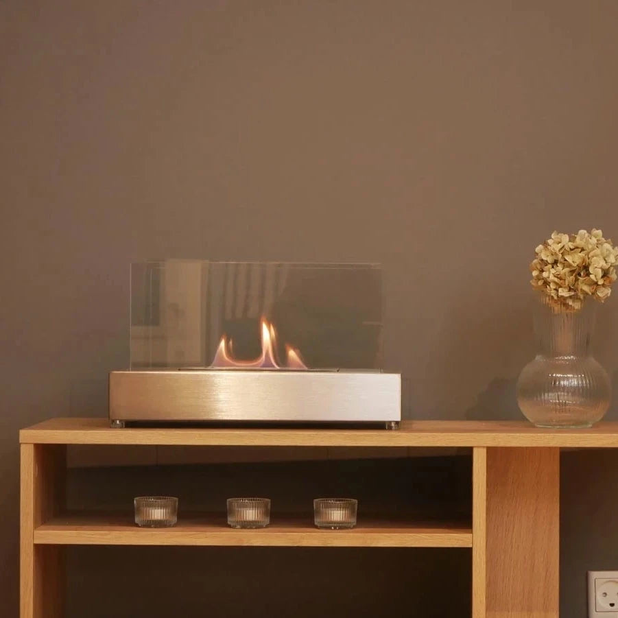ScandiFlames Lambeth steel tabletop bioethanol fireplace lit on a wooden console table