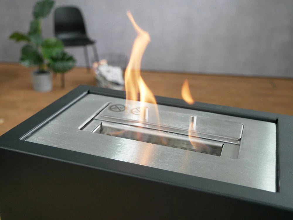 Close-up of the Bio Grate bioethanol insert's burner with lit flame