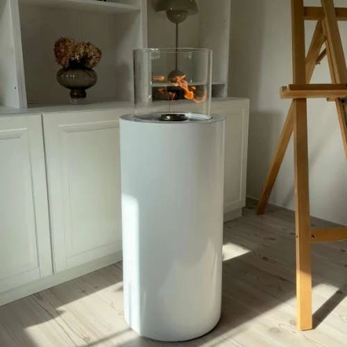 ScandiFlames Dualis White floor-standing bioethanol fireplace with a lit flame in a sunlit studio room