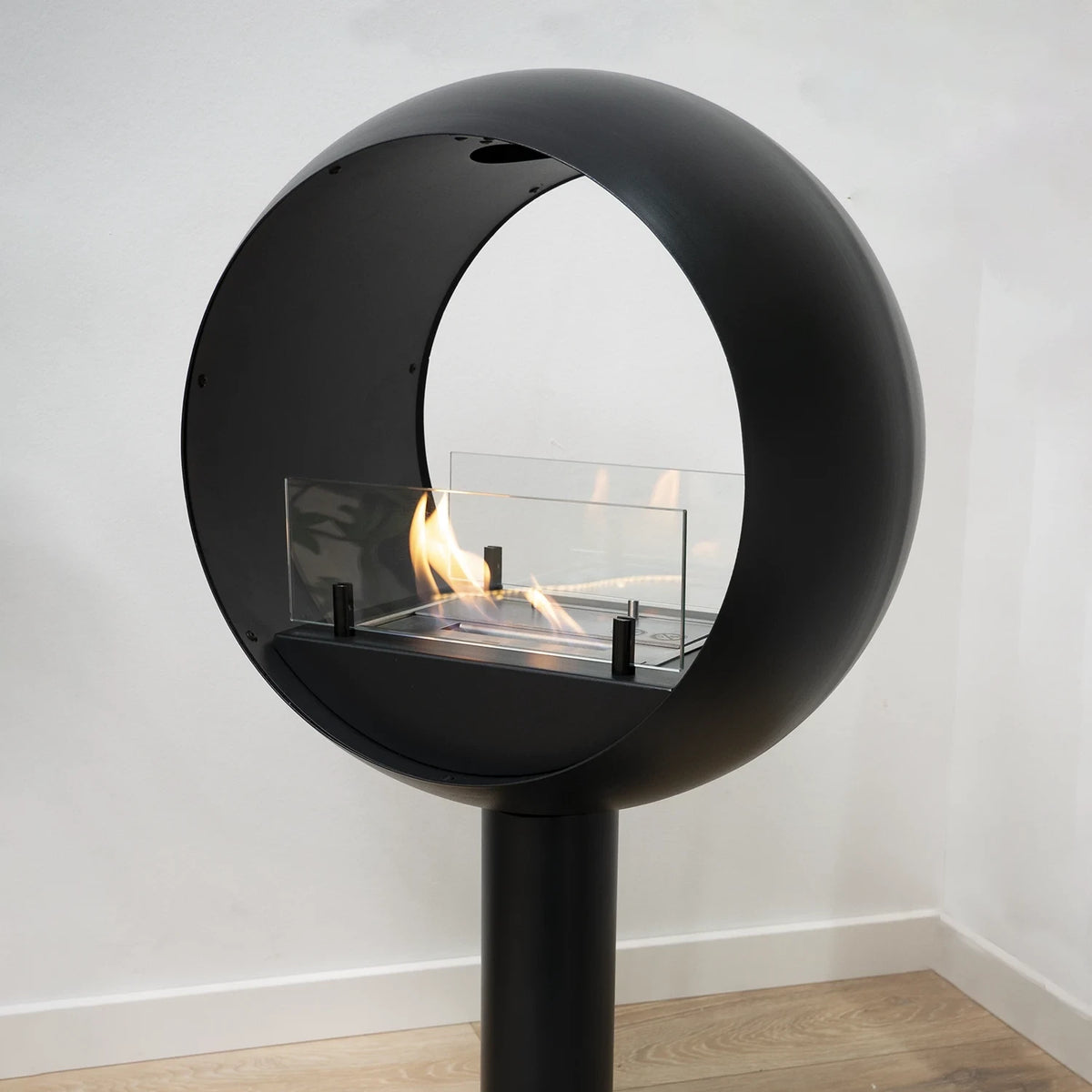 Edmonton 2-sided freestanding bioethanol fireplace lit in the corner of a bright room