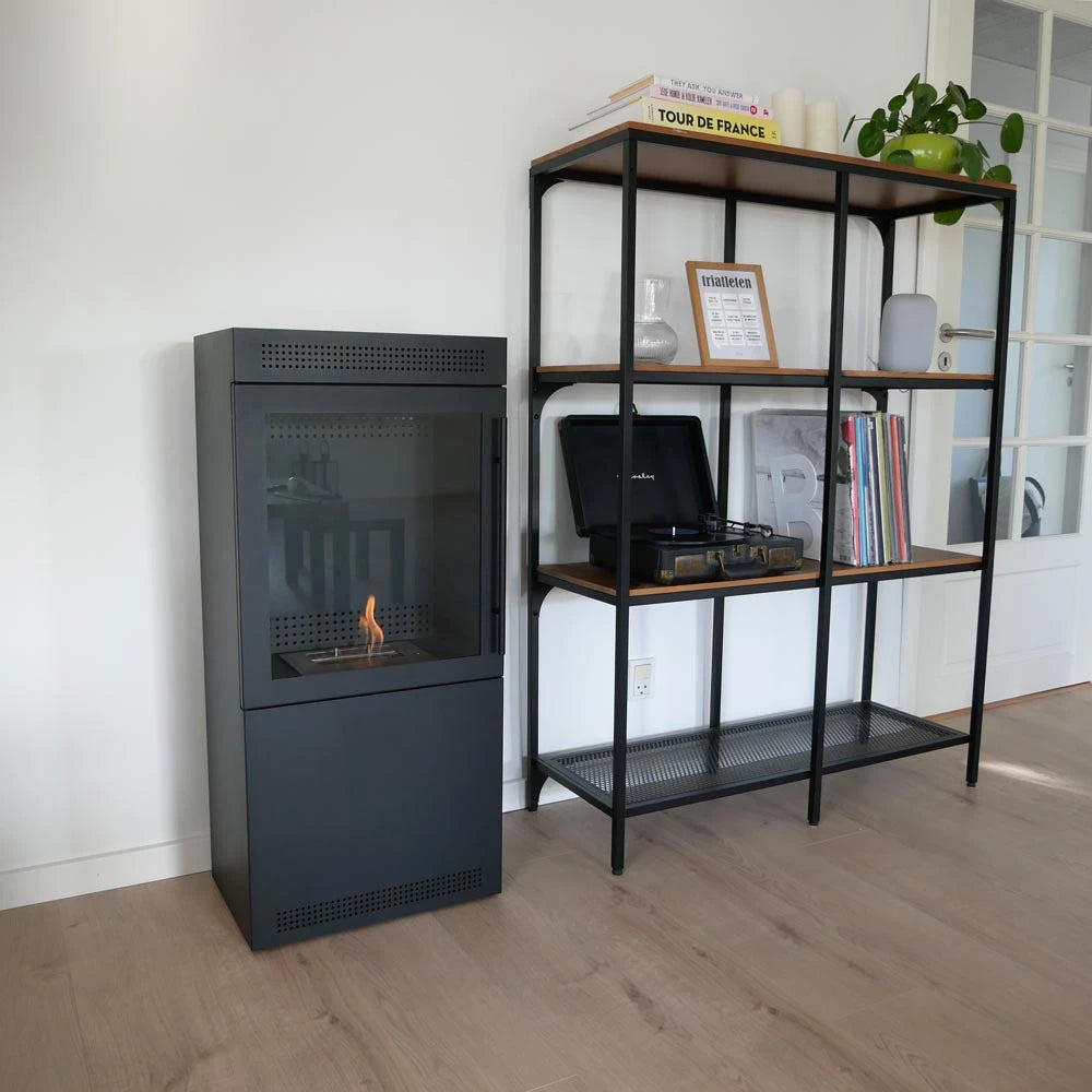 Jackson bioethanol wood stove, lit flame, living room with shelving unit and record player