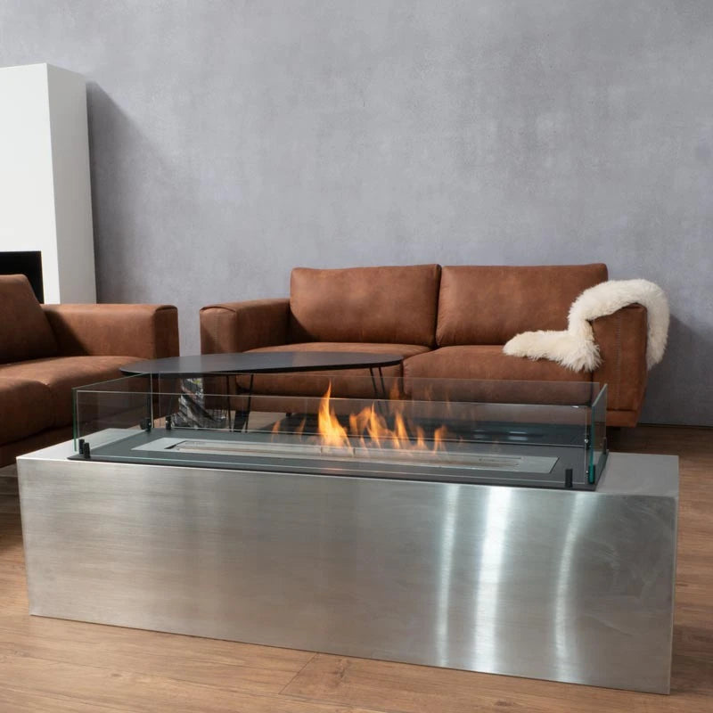 Foco Free 1200 built into a stainless steel coffee-table housing with a lit flame, living room with brown sofa