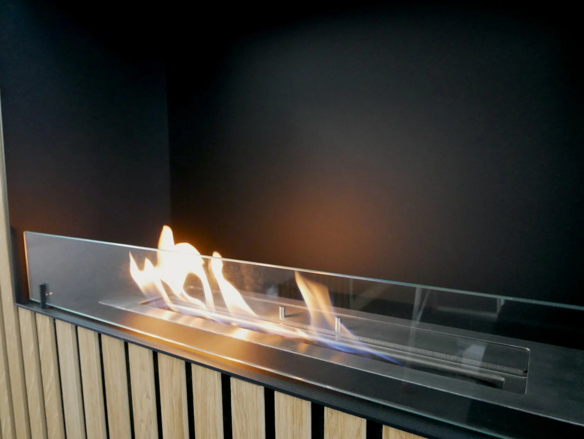 Foco One 800 built into a light oak wood-slat wall with a lit flame, close-up view