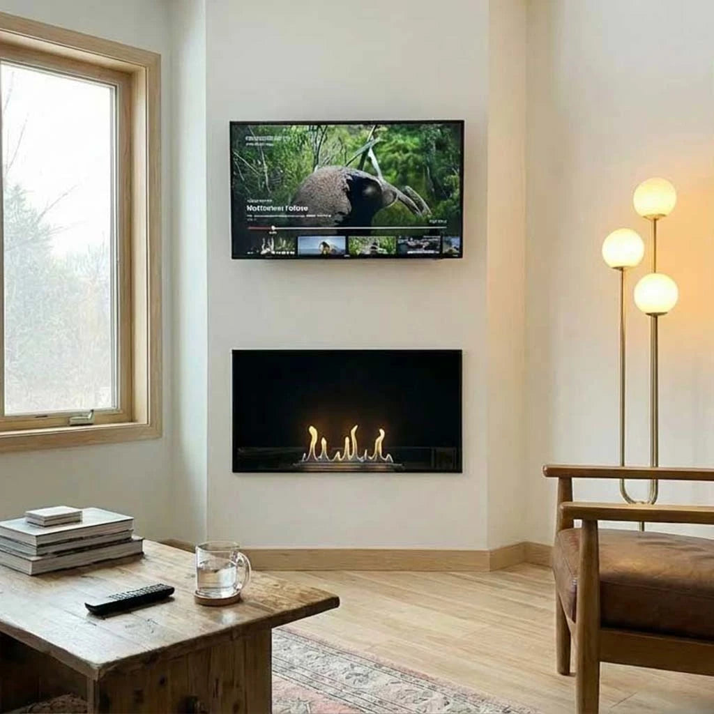 Foco One 800 built into a plastered living room wall below a wall-mounted TV, lit flame, cosy real home
