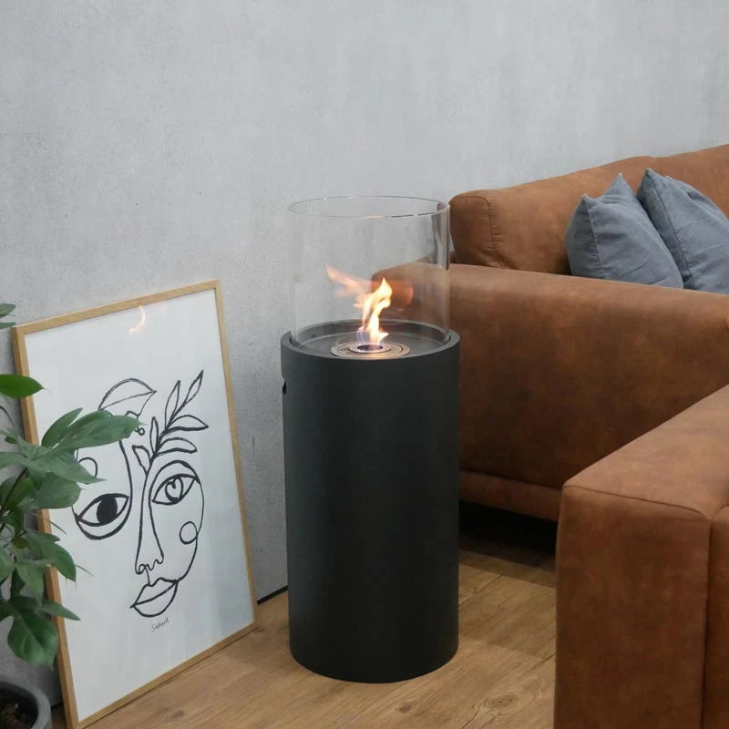 ScandiFlames outdoor black bioethanol fireplace lit beside a leather sofa and framed art print
