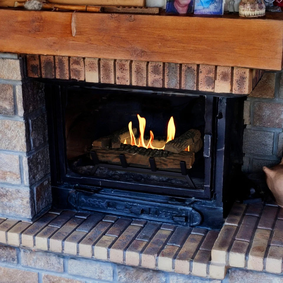 Close-up of the Grate M bioethanol fire insert lit inside a real stone fireplace