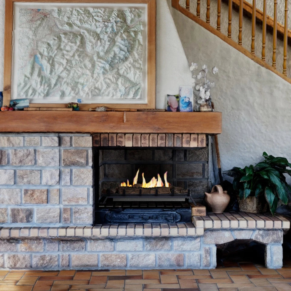 Grate XL bioethanol fire insert lit inside a real stone fireplace with a wooden mantel and staircase