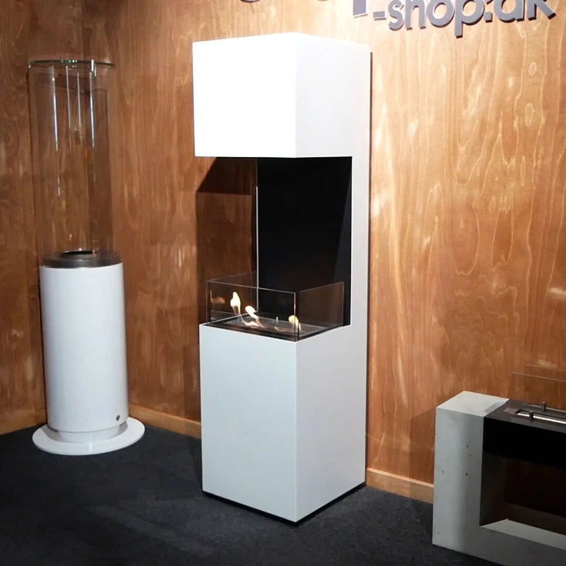 Open 3-sided white bioethanol fireplace lit at a trade showroom display