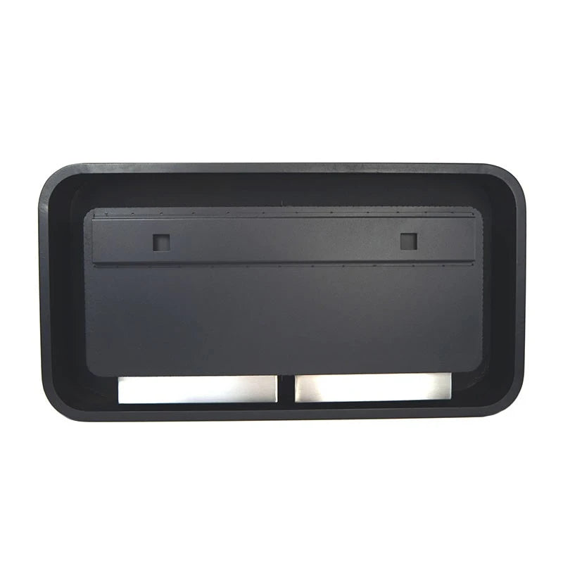 Close-up top-down view of the twin manual bioethanol burner trays inside the black wall-mounted fireplace, unlit