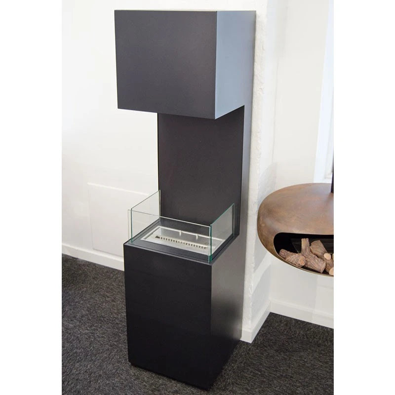 Open 3-Sided black bioethanol fireplace, unlit, beside a log holder and side table