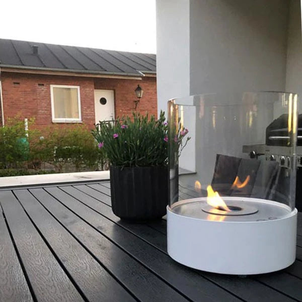 Southwark white round tabletop bioethanol fireplace on an outdoor terrace table, lit flame, real customer photo
