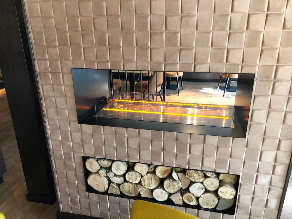 Foco Myst Two 1000 built into a wall, lit flame, lifestyle photo