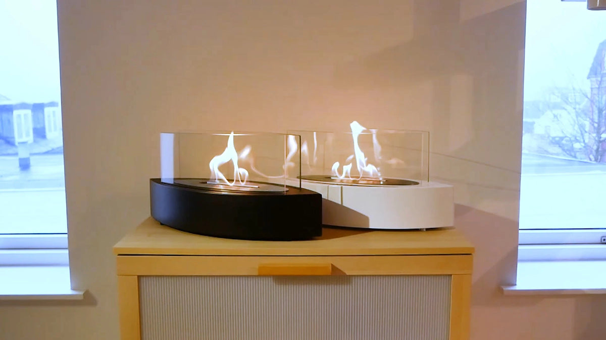 Oval Table Bio Fireplace shown in both black and white, both lit