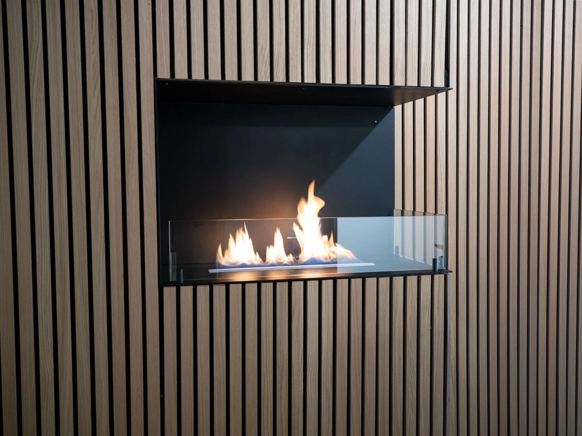Foco Corner Right 800 built into a light oak wood-slat corner wall, close-up view with a realistic lit ethanol flame.