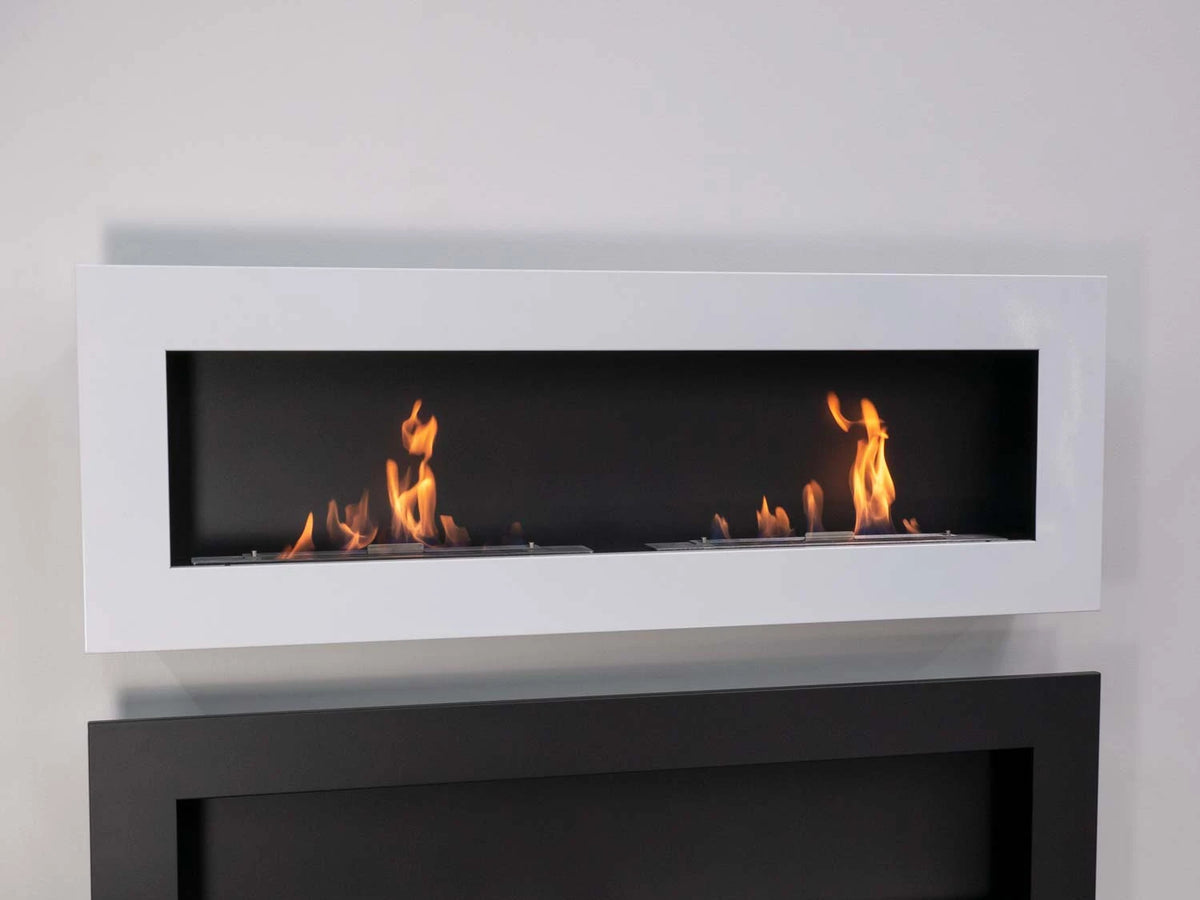 Murus 1600 glossy white bio fireplace mounted on a plain grey wall above a dark cabinet, lit with a realistic flame