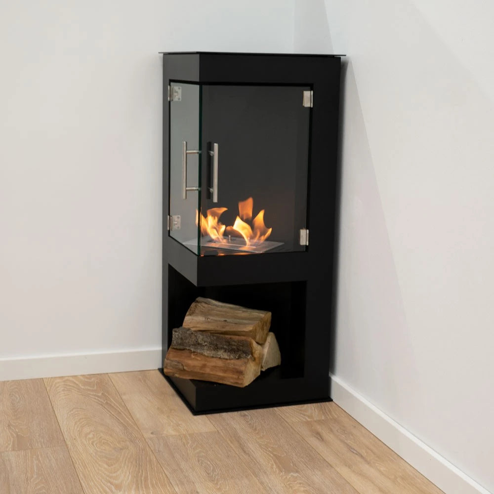 Alaska corner bioethanol stove, lit flame, with decorative logs in the bottom storage compartment