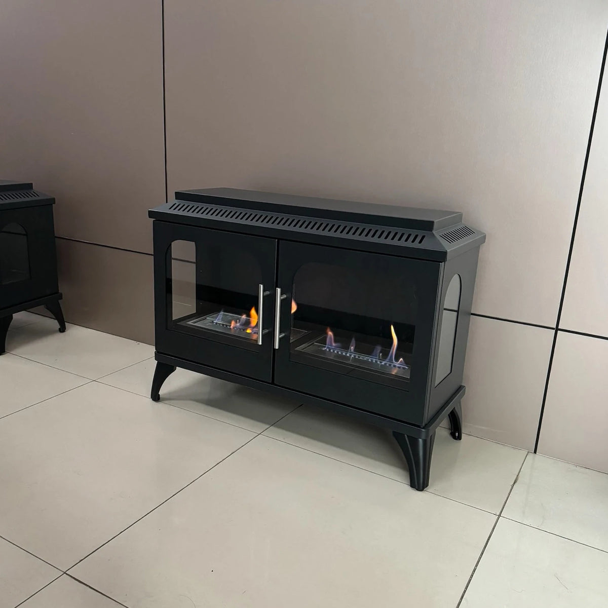 Atlanta Double bioethanol stove with visible flame shown in a showroom setting